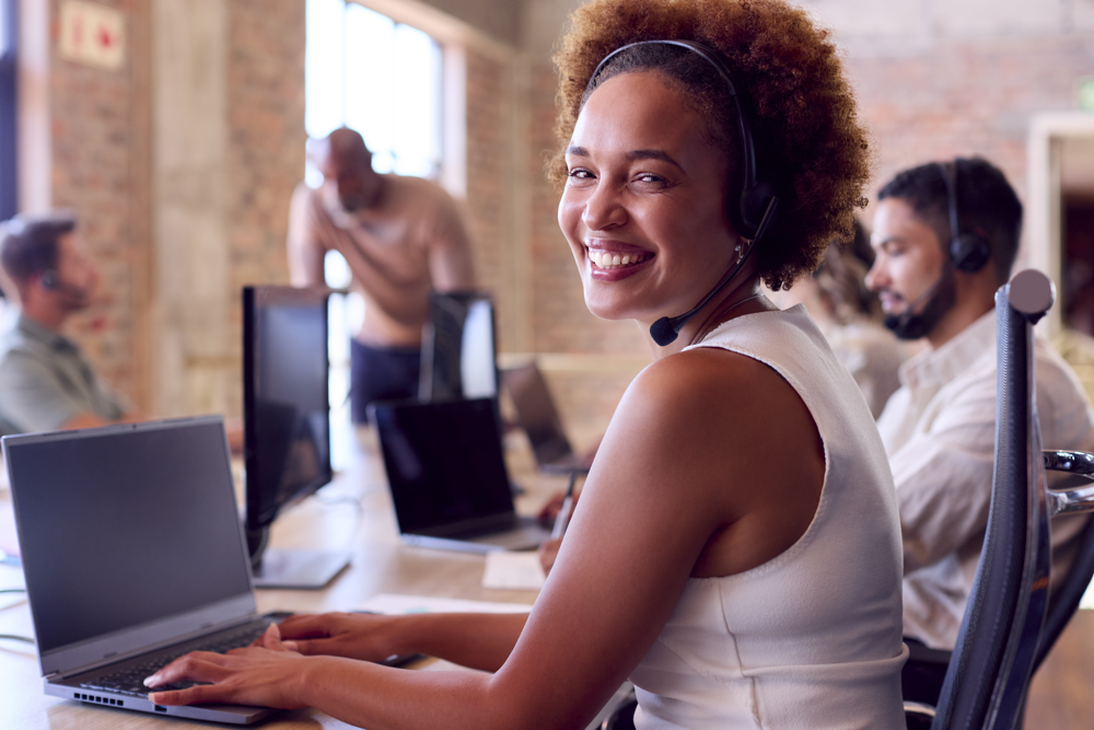 Woman working at a laptop in customer support