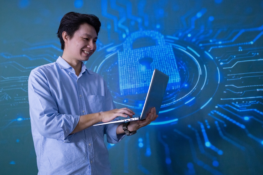 smiling-young-man-using-laptop