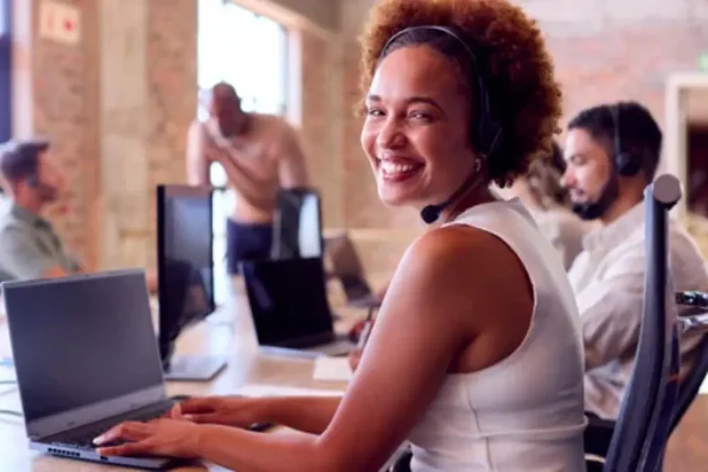 Woman working at a laptop in customer support
